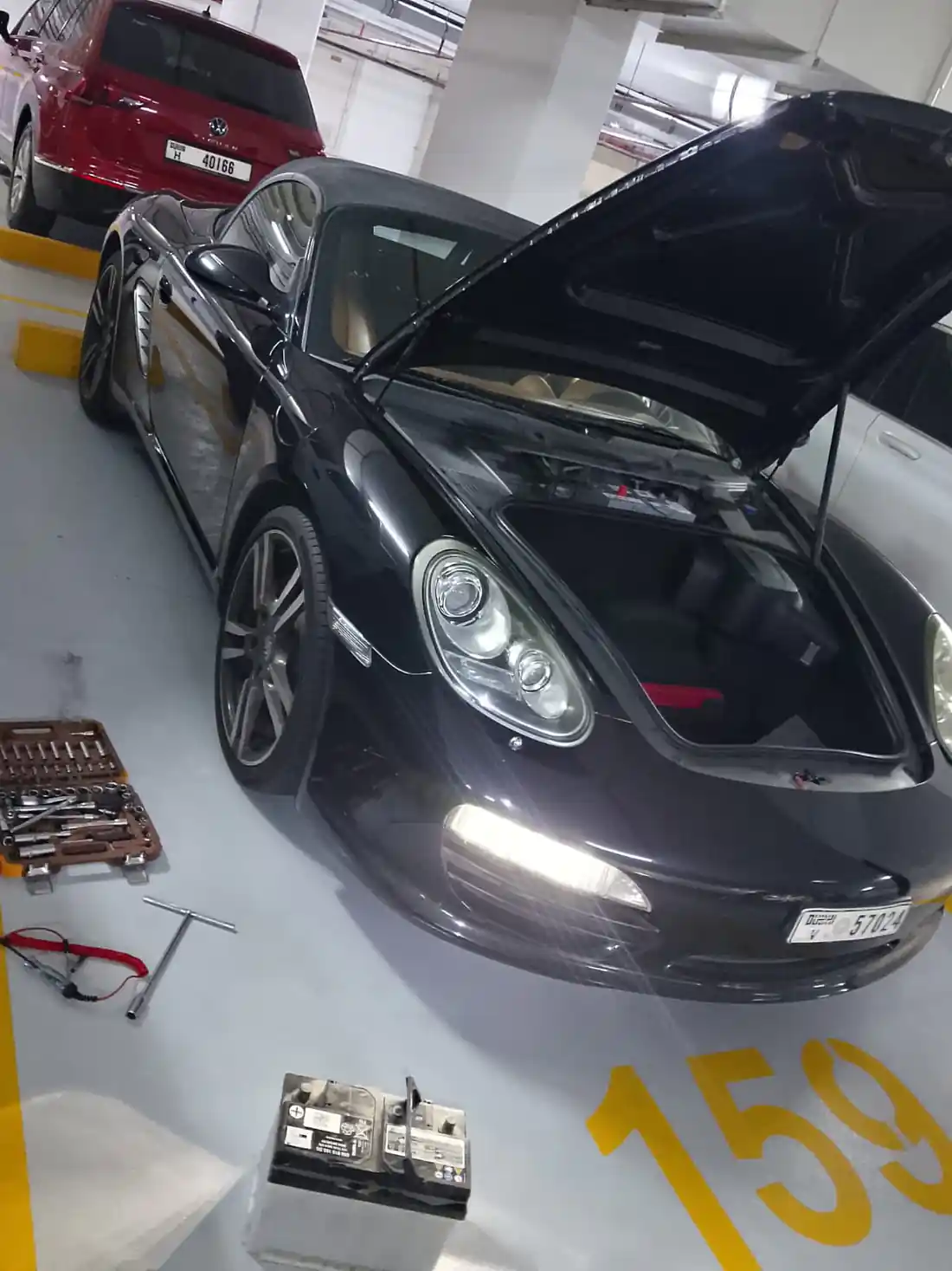 Mobile battery replacement in progress on an SUV engine bay